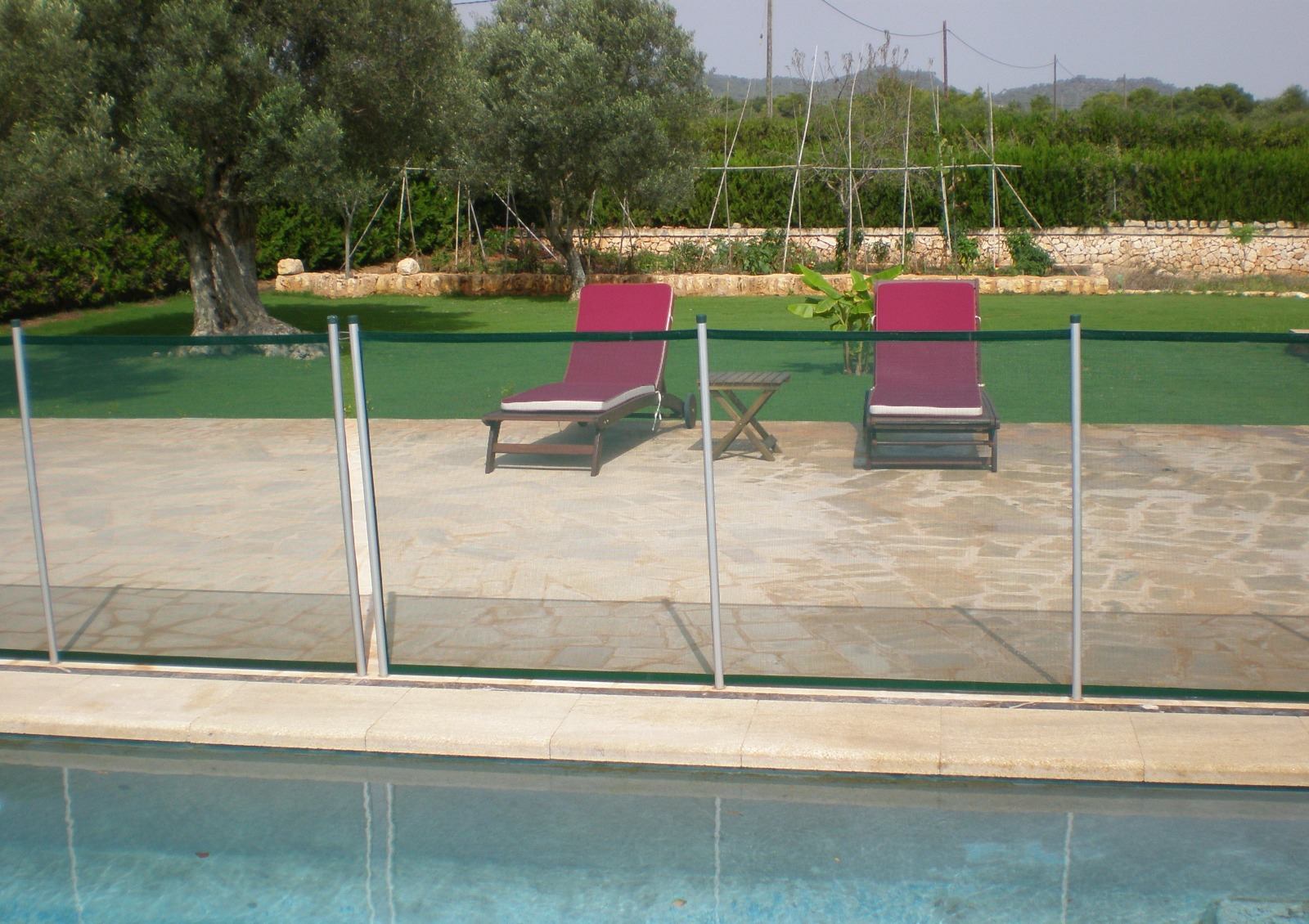 Transparent safety fence around a pool