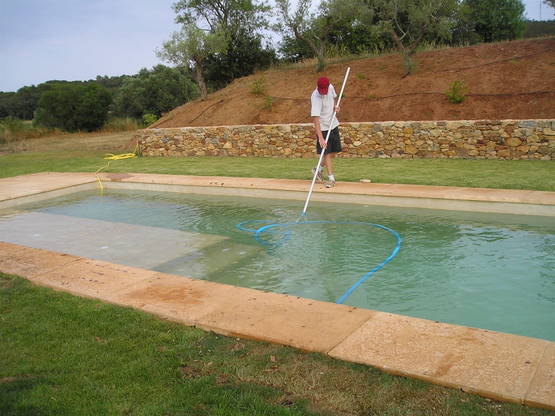 Technician cleaning a pool